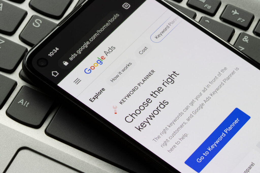 an iphone on a keyword displaying a Google Ads webpage that read "choose the right keywords"