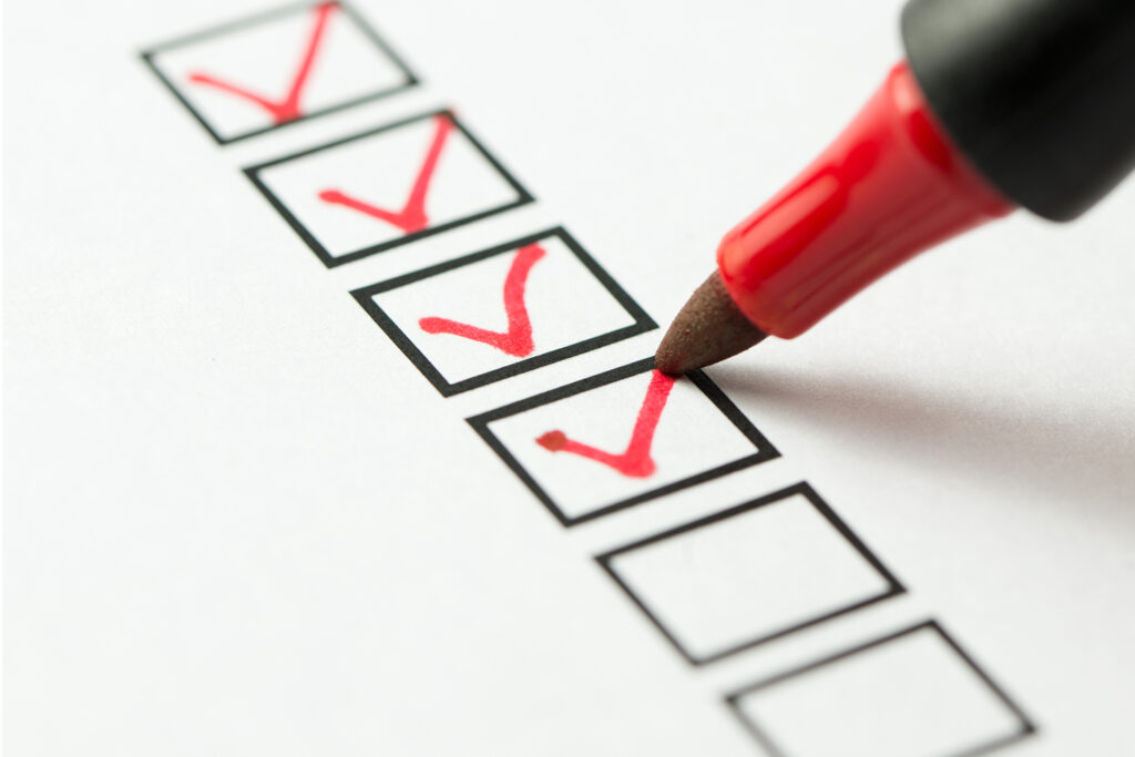 a close-up of a pen ticking check boxes
