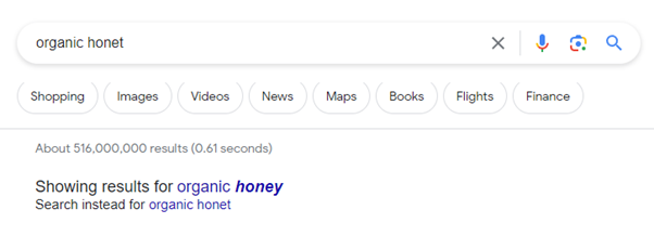 A screenshot of the Google search bar with a misspelling of "organic honey" and the auto-corrected results below.