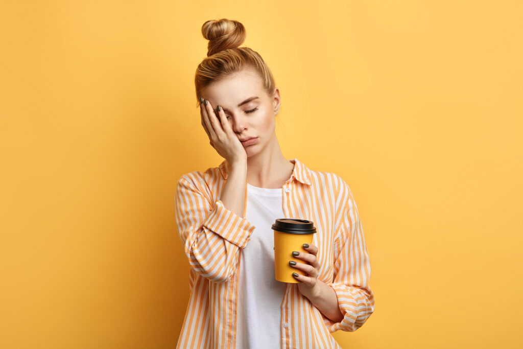 a tired young woman with a coffee who has slept on these social media content types