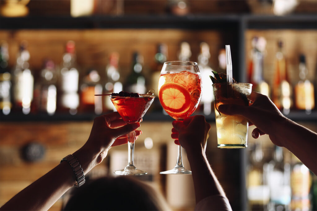 clinking cocktail glasses to a successful bar advertising strategy