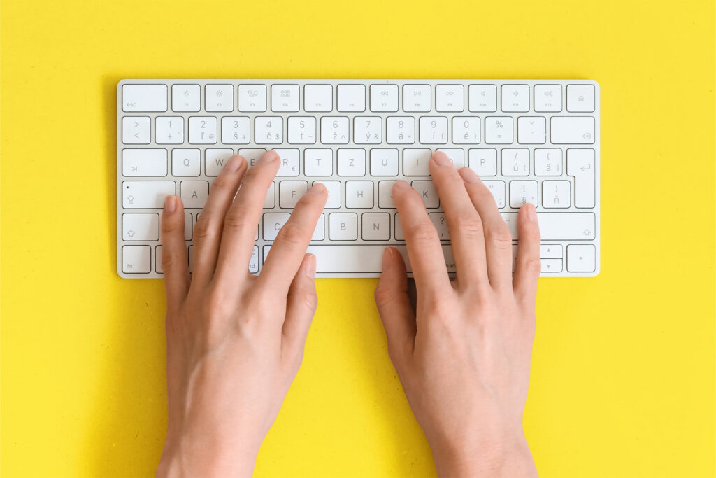 hands typing on a keyboard
