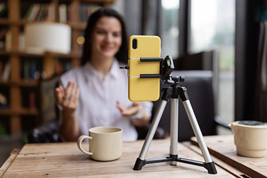 an influencer recording content in a cafe for paid social media ads