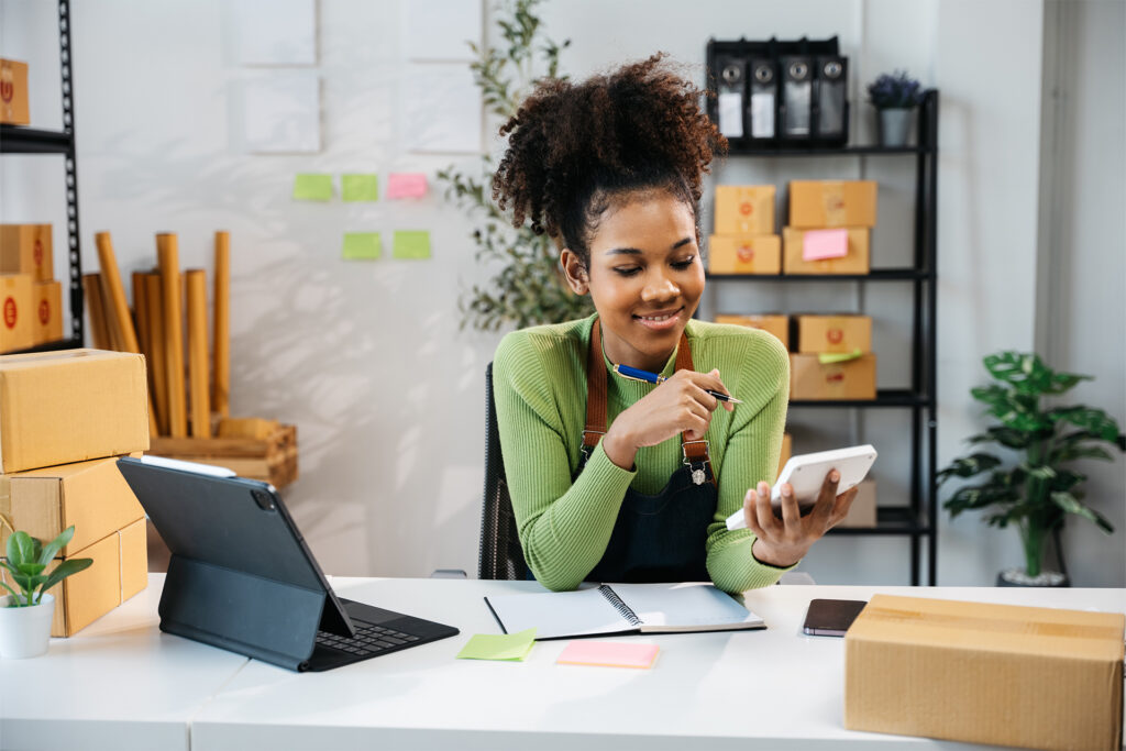 an ecommerce businessowner in their office deciding whether shopify or etsy is best for them
