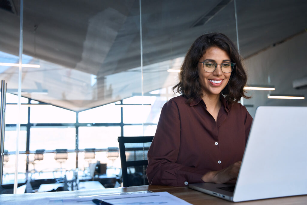 a marketer smiling as she sees positive results from demand gen advertising