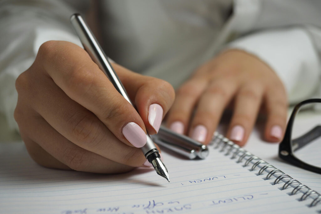 a content writer jotting down notes in a notebook