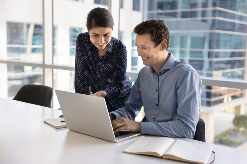 two content writers happily reviewing copywriting for business