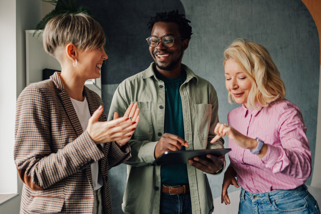 a group of business people checking their sales on a table and celebrating