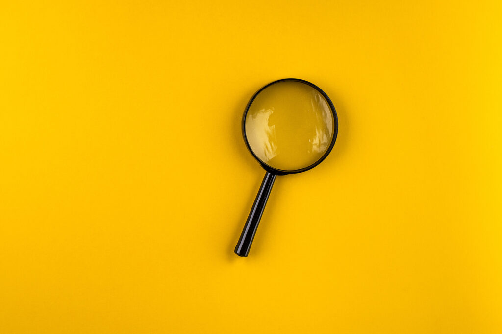 a magnifying glass on a yellow background