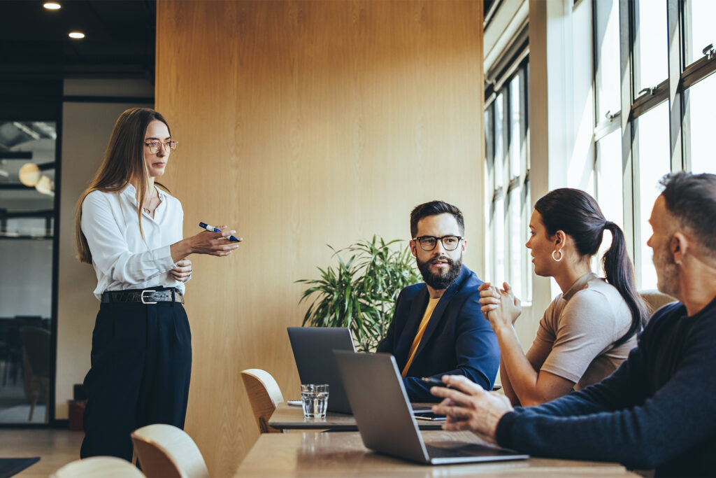 a business leader discussing the company marketing strategy with her team