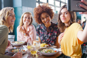 a group of happy diners taking a selfie for google reviews for restaurants