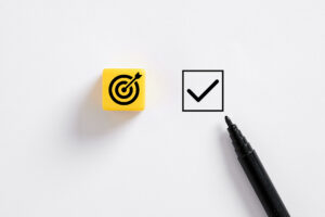 a representation of website visitor tracking via a yellow target symbol next to a pen hovering over a check box