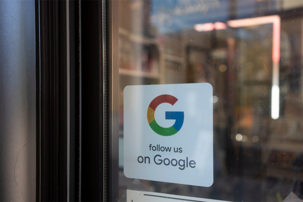 a restaurant with a sticker on the door telling customers to follow them on google