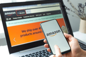 a small business owner checking their amazon listing optimisation on their laptop and phone