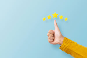 A blue background with a person doing a thumbs up to represent Google Product Reviews.