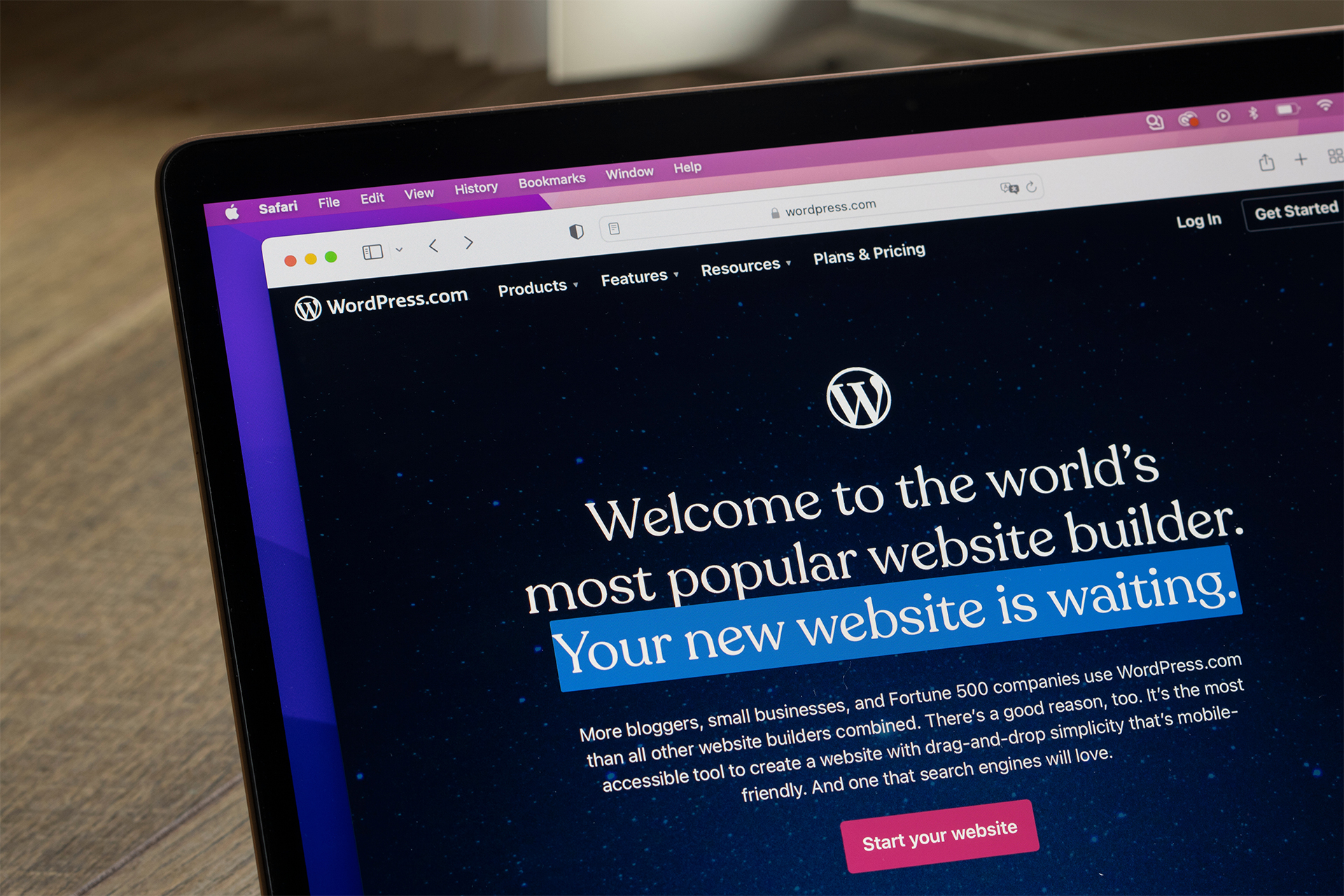 a close up of a laptop with the WordPress homepage open on the screen