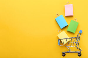 abandoned basket strategy represented by paper shopping bags falling into a trolley