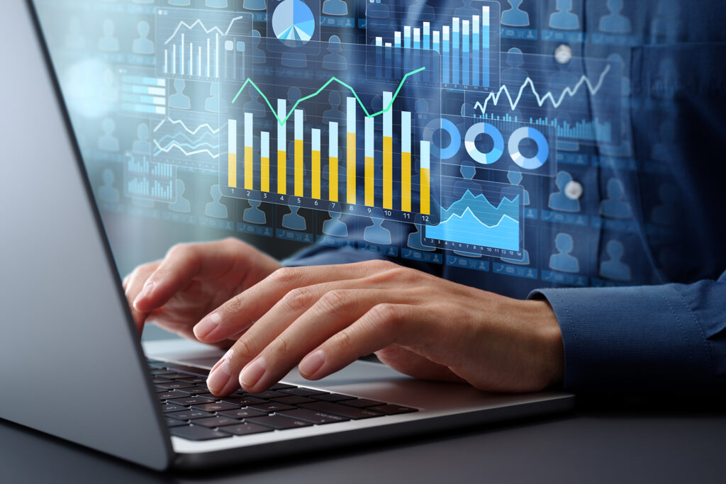 a marketer working on a laptop with graphs demonstrating increased conversions superimposed over them
