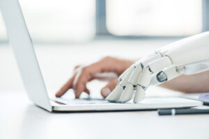 content marketing automation represented by robot hands on a laptop